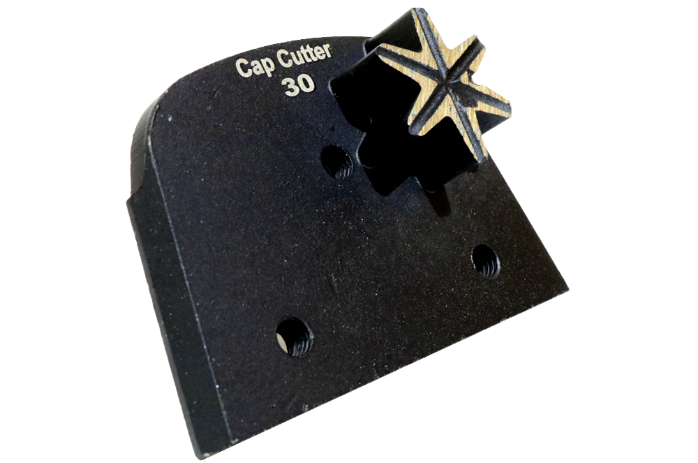 Black cap cutter tool labeled 'Cap Cutter 30' with a star-shaped cutting bit attached. Used for trimming bottle caps or similar openings.