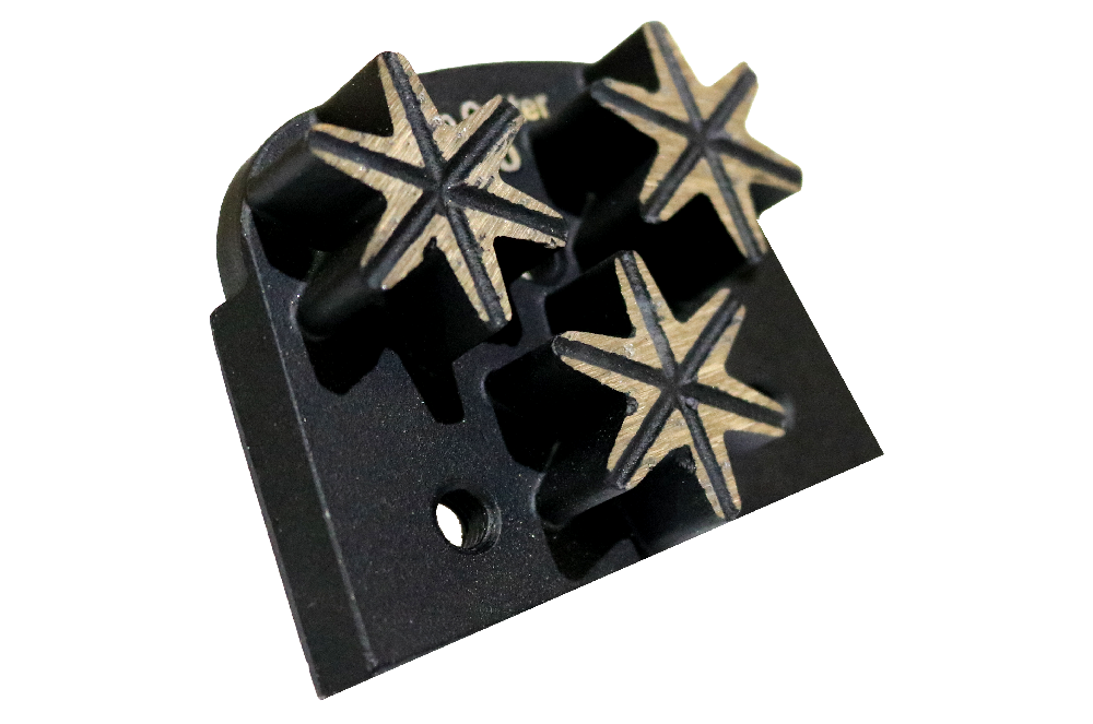 Black plastic tool block with three six-point star-shaped metal tips arranged in a row.