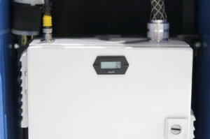 White industrial control cabinet with a digital hour meter on the front and cable connections on top.